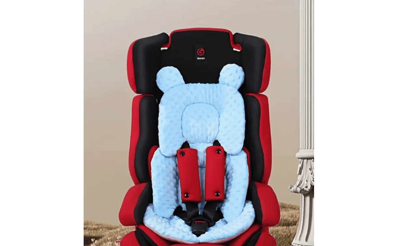 The blue insert is an example of an aftermarket (and unsafe) car seat accessory.