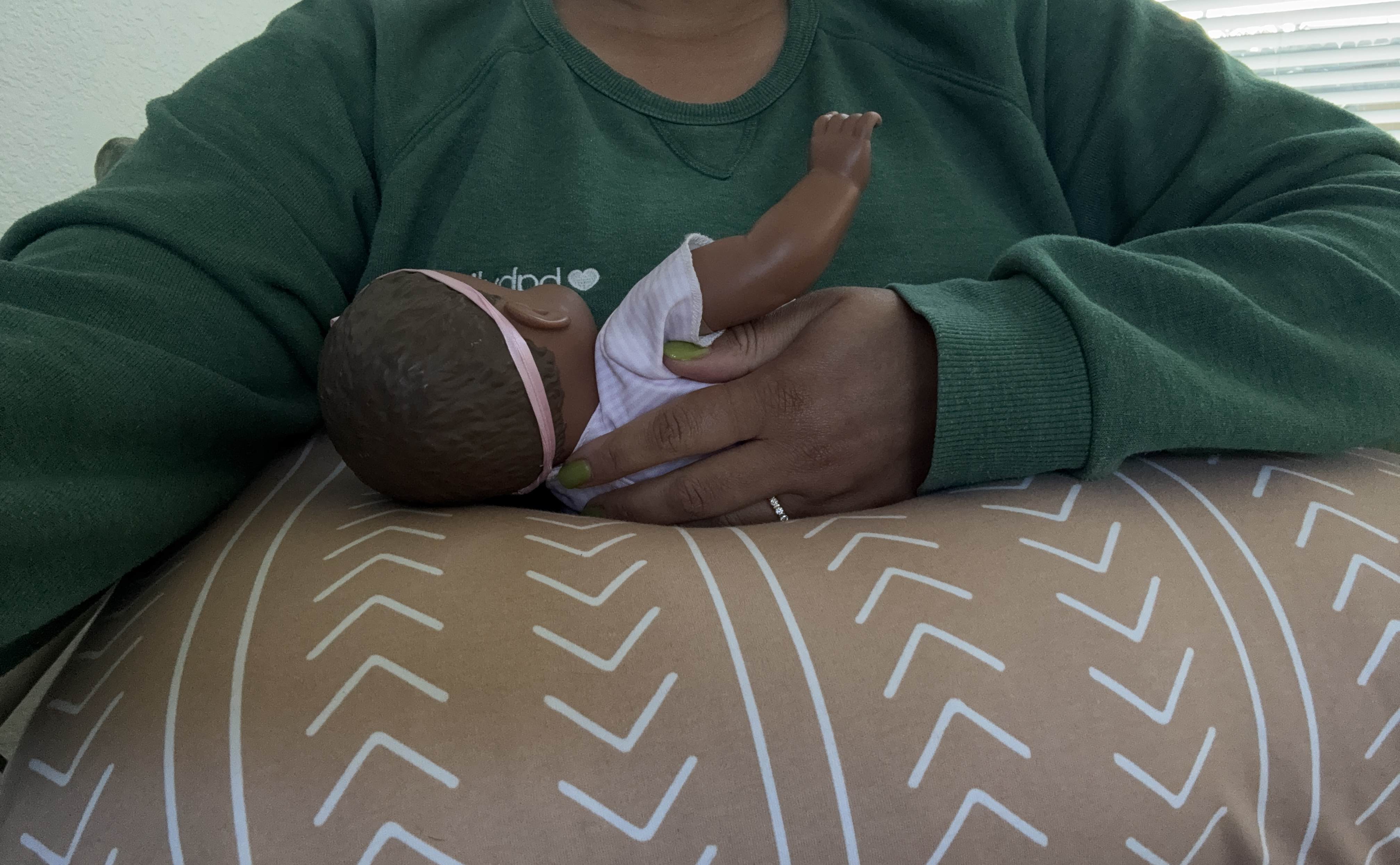 Boppy demonstration photo with baby doll.