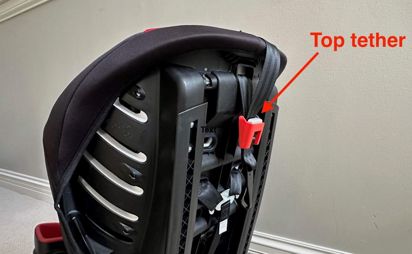 The top tether on the rear of an Evenflo Sonus 65 Convertible Car Seat.