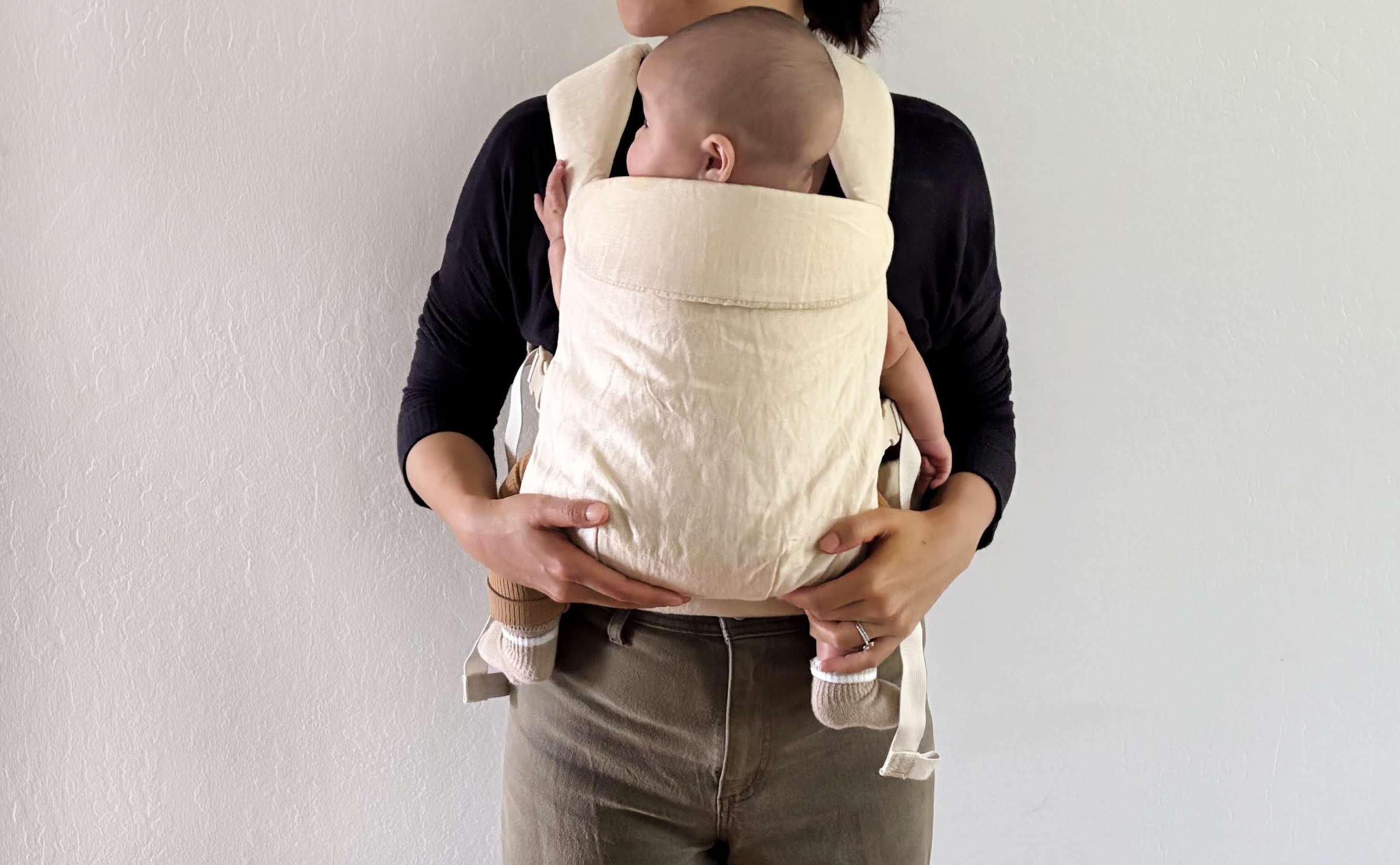 Parent wearing baby in the Wildbird Aerial Carrier.