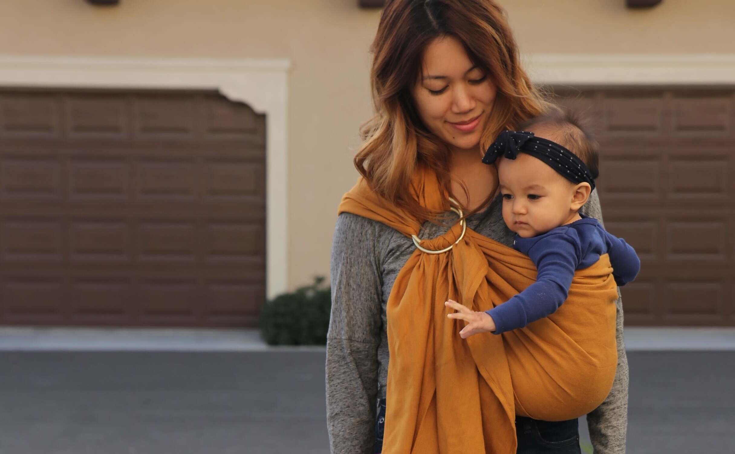 Parent and baby using a ring sling.