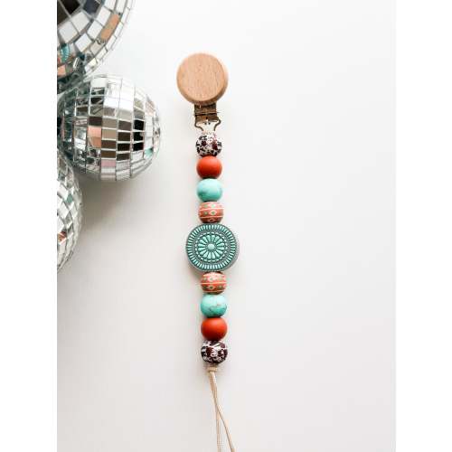 The turquoise junkie Pacifier Clip