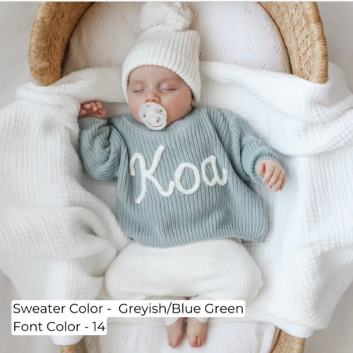 Hand-knitted sweater with baby’s name embroidered