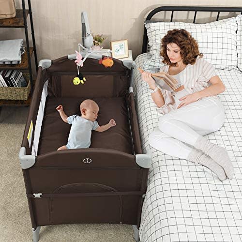 BABY JOY 5-in-1 Baby Bedside Sleeper, Pack n Play with Bassinet, Side Sleeper for Babies w/Oversized Diaper Changer, Music Box & 3 Hanging Toys, Carrying Bag for Easy Transportation (Coffee)