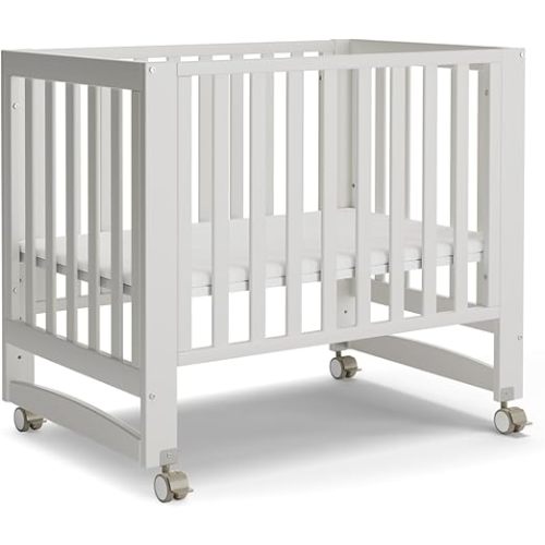 MAMAZING EvoNest 6-in-1 Convertible Baby Mini Crib with Wheels | GREENGUARD Gold Certified, New Zealand Pine Wood, 4 Adjustable Heights, Rocking Mode, Small Spaces Design, White