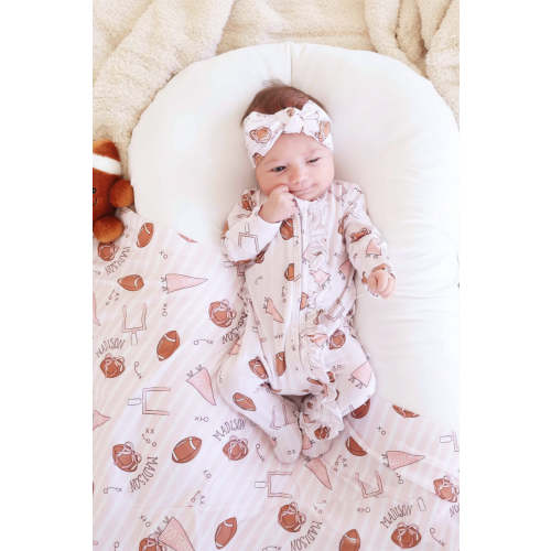 Tiny Touchdowns Ruffle Zipper Footie in Pink | Caden Lane