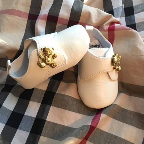 Baby pram shoes with strap over and gold teddy button …. These are BABY size shoes. The listing says “kids size” but they are baby sizes!