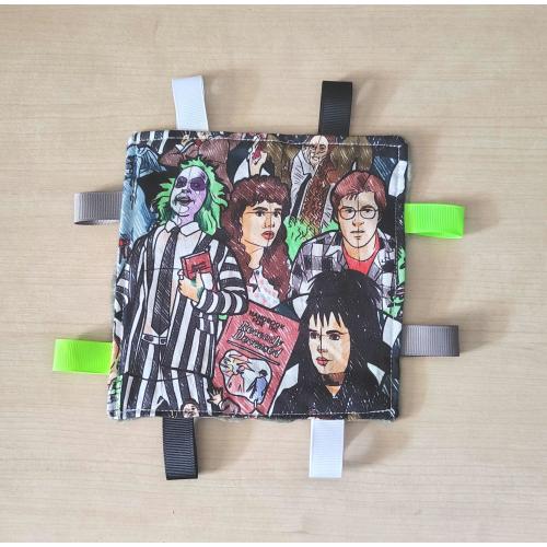 Beetlejuice inspired Baby crinkle toy. 6x6 size. Minky on the back. Ribbons to pull on