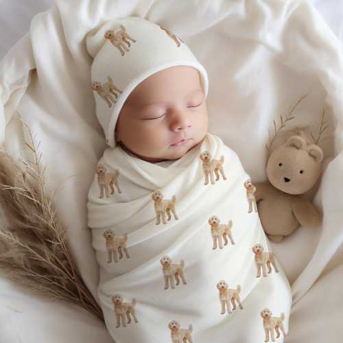 Goldendoodle baby swaddle blanket set with matching beanie. Soft dog print wrap perfect for newborn coming home outfit or cozy nursery decor