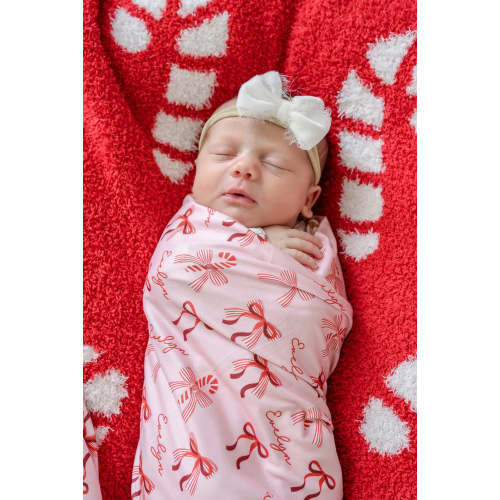 Personalized Christmas Swaddle Blanket in Peppermint Bows | Caden Lane
