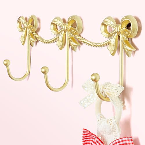 KYIAANY Gold Bow Hooks for Girls: Cute Triple Bows Hooks Wall Mount for Nursery Bedroom Bathroom for Hanging Towel Bag Robe Jewelry - Metal 3 Hooks Coquette Room Decor for Girly Daughter Kids Baby