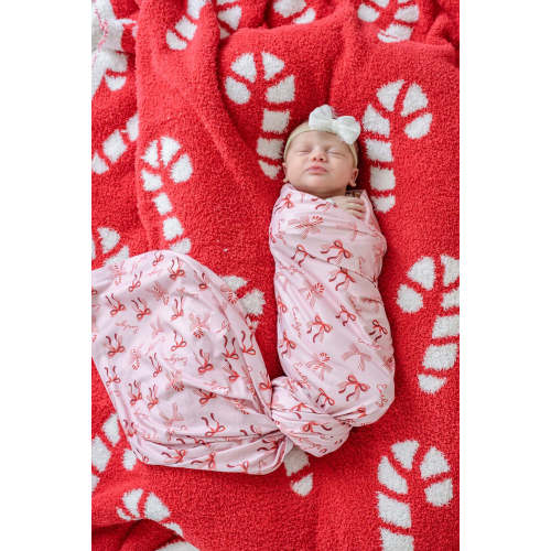 Personalized Christmas Swaddle Blanket in Peppermint Bows | Caden Lane