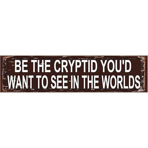 Funny Cryptid Gift – Be the Cryptid You'd Want to See in the World Metal Sign, Bigfoot Mothman Flatwoods Monster Rustic Wall Art 16 x 4 Inch