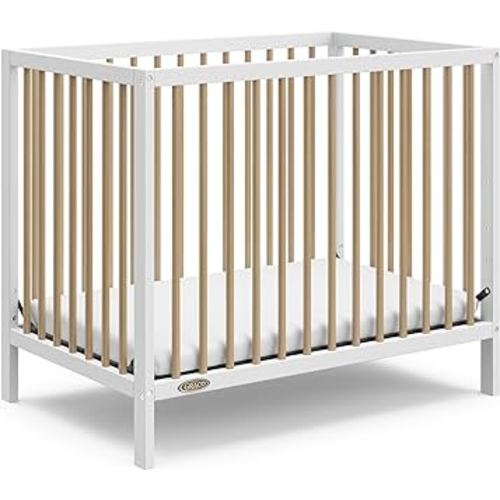 Graco Teddi 4-in-1 Convertible Mini Crib with Bonus Water-Resistant Mattress (White/Driftwood) – GREENGUARD Gold Certified, 2.75-Inch Mattress Included, Ideal for Small Spaces, Easy 30-Minute Assembly