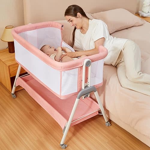 ANGELBLISS Baby Bassinet Bedside Crib with Storage Basket and Wheels, Easy Folding Bed Side Sleeper Adjustable Height Portable Crib for Newborn (Pink)