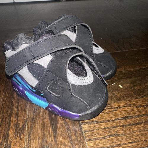 Black and purple sneakers with blue and purple...