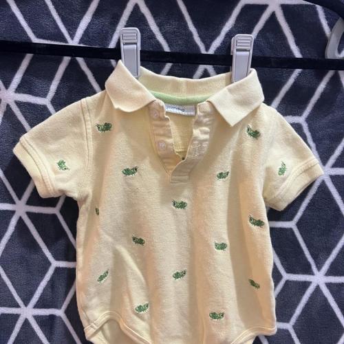 Yellow baby polo shirt with green grasshopper...