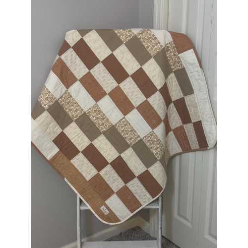 Handmade Baby Boy Quilt. Colors are different shades of brown, tan, cream and white. Size 41” x 39”