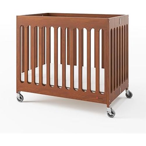 Foundations Boutique Compact Folding Crib, Modern, Contemporary, Mini Crib for Guest Rooms, Vacation Homes, and Small Nurseries, Available in 5 Finishes, Mattress Included (Cherry)