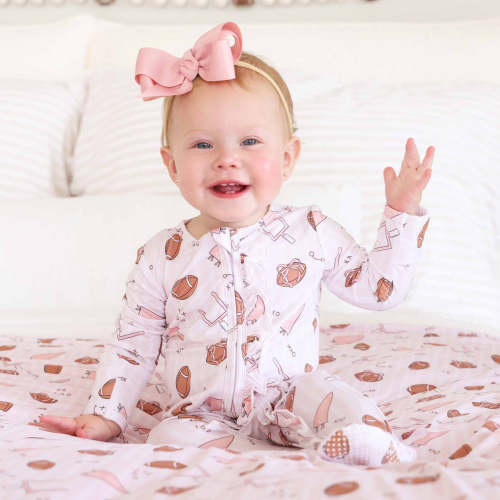 Tiny Touchdowns Ruffle Zipper Footie in Pink | Caden Lane