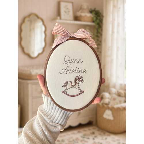 Baby name sign embroidered with a rocking horse