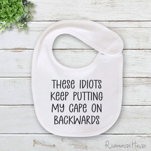 Funny Baby Bib These Idiots Keep Putting My Cape On Backwards