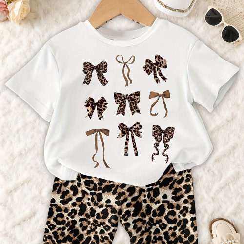 2pcs Set - Fashionable And Easy Summer Pullover And Shorts Outfit for Baby Girls. Includes a White Short-Sleeve T-Shirt with a Bow Pattern And Leopard Print Elastic Waist Pants. Cute And Comfortable Casual Wear for Outdoor Activities for Baby Girls.