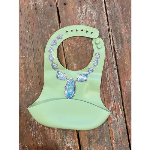 Blue lariat necklace on green no drip baby bib