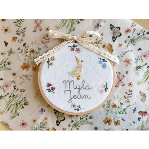 Embroidered plaque with baby’s name, nursery rhyme goose and a minimalist floral wreath | baby name announcement sign and nursery wall decor