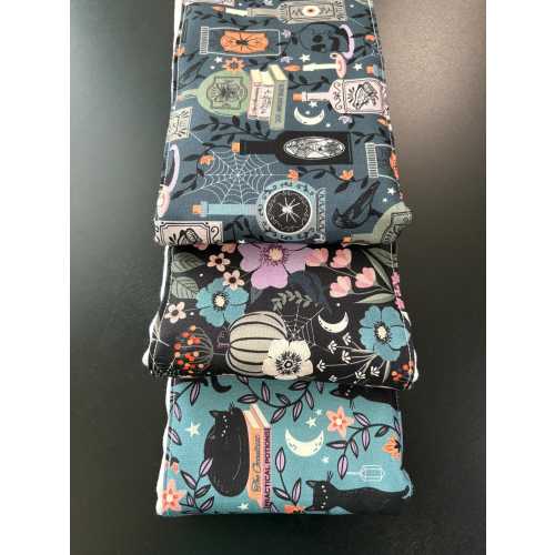 Burp cloths, black cat, potions, spider webs, witches, flowers, pumpkins, baby shower