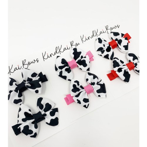 Cow print small hair bows, toddler pigtail bows, pink cow print, red cow print, country western bows. farm theme bows, country western theme