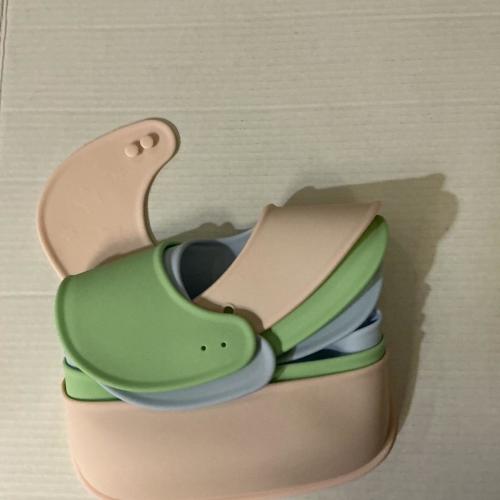 Set of 3 silicone bibs in blue, pink, and green...