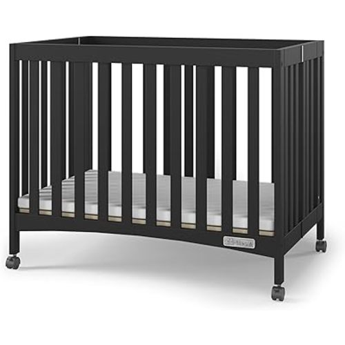 Child Craft London Mini Compact Folding Portable Crib with 2” Crib Mattress and 2 Easy Roll Locking Wheels, Durable Pine Wood Construction (Ebony Black)