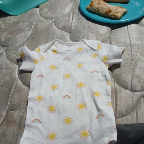 Primary white baby bodysuit with yellow suns and...