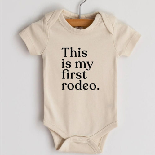 “This Is My First Rodeo” Organic Cotton Baby Onesie – Small Boots, Big Debut