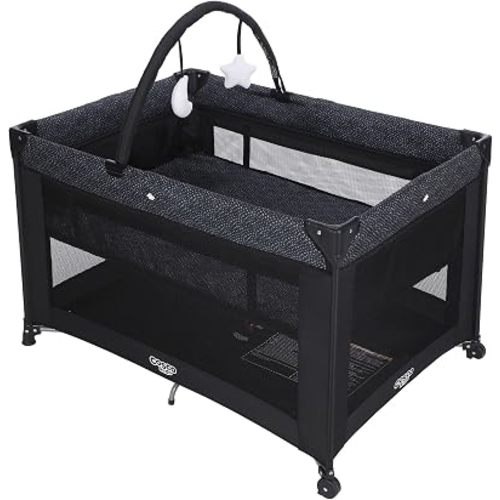 Cosco Kids Origins Plus Playard – Portable Playpen with Zip-On Bassinet & Toy Arch, Carry Bag & Wheels, Lightweight Compact Fold Travel Crib, Breathable Mesh Baby Play Yard – Noir Dot