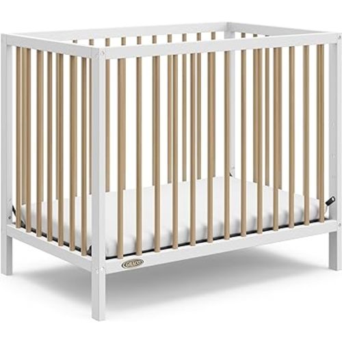Graco Teddi 4-in-1 Convertible Mini Crib with Bonus Water-Resistant Mattress (White with Driftwood) – GREENGUARD Gold Certified, 2.75-Inch Mattress Included, Convenient Size, Easy 30-Minute Assembly