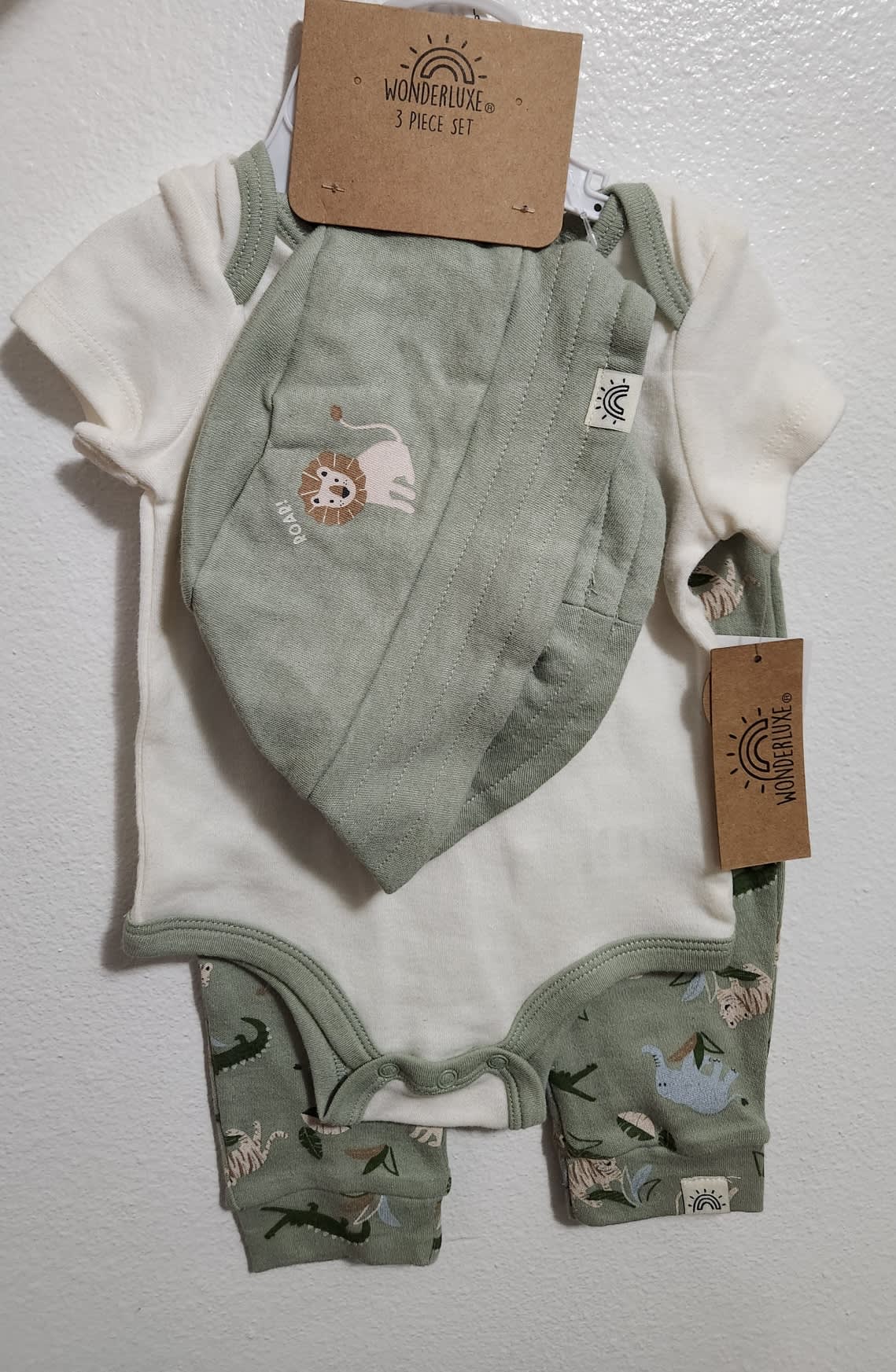 Animal 3-Piece Baby Outfit Set that includes a short-sleeve bodysuit, printed jogger pants, and a matching bucket hat.