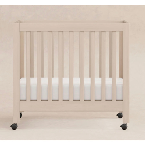 Origami Portable Mini Crib With Wheels | Babyletto in washed natural