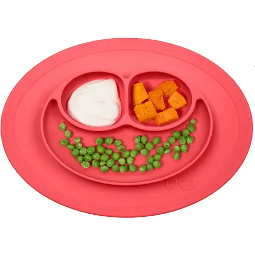 ezpz Mini Mat (Coral) - 100% Silicone Suction Plate with Built-in Placemat for Infants + Toddlers - First Foods + Self-Feeding - Comes with a Reusable Travel Bag - 6 Months+