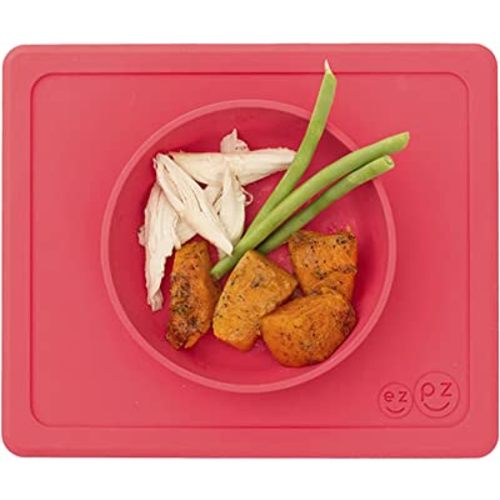 ezpz Mini Bowl for 12 Months+ (Coral) - 100% Silicone Suction Bowl with Built-in Placemat for Toddlers - Comes with a Reusable Travel Bag