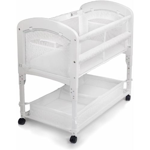 Arm’s Reach Cambria Co-Sleeper Bedside Bassinet Featuring Height-Adjustable Legs, Curved Wooden Ends, Breathable Mesh Sides with Pockets, and Large Lower Storage Basket, White