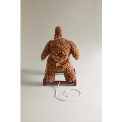 Plush toy dog with wheels