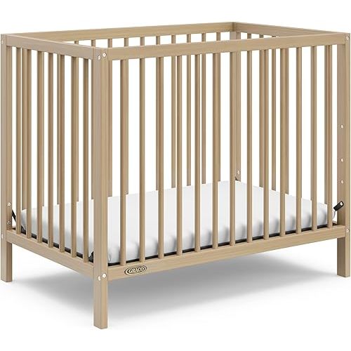 Graco Teddi 4-in-1 Convertible Mini Crib with Bonus Water-Resistant Mattress (Driftwood) – GREENGUARD Gold Certified, 2.75-Inch Mattress Included, Ideal for Small Spaces, Easy 30-Minute Assembly