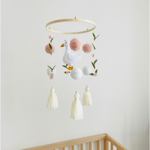 Baby mobile with white felt goose and small pink and white pompoms