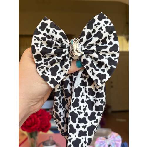 Cow print bow with boots charm