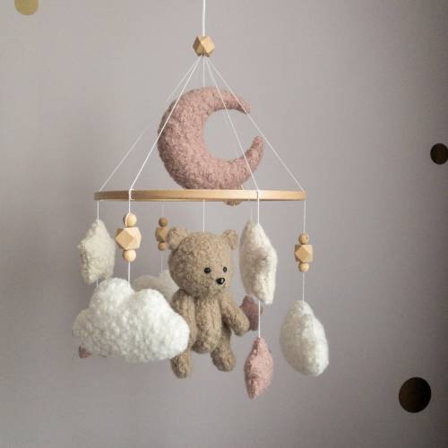 Pink plush mobile with bear for a baby girl’s room