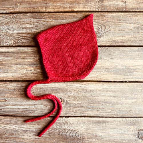 Red pointy bonnet for baby, hand knitted with soft pure merino wool
