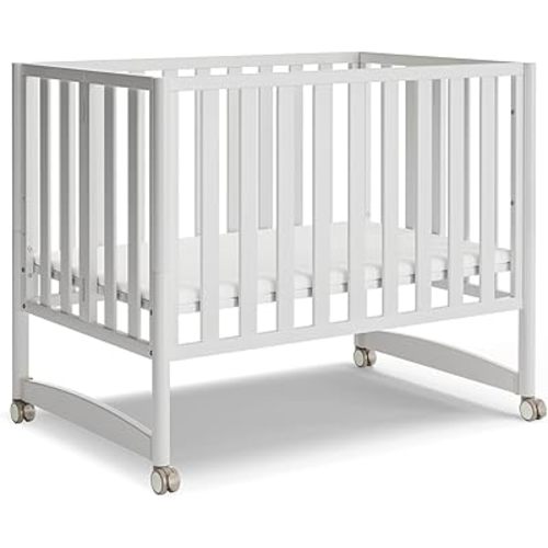 MAMAZING EvoNook 6-in-1 Convertible Mini Crib, 100% New Zealand Wood, Portable Mini Cribs with Wheels for Small Spaces, GREENGUARD Gold Certified, White