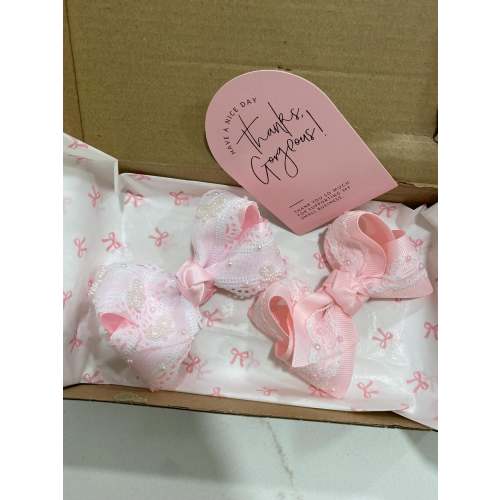 Pink bow with pearl details and scalloped lace